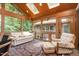 Cozy sunroom filled with natural light from skylights, featuring comfortable seating and outdoor views at 6 Womble Cir, Durham, NC 27705