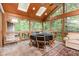 Inviting sunroom with a vaulted ceiling, featuring a dining table set and scenic backyard views at 6 Womble Cir, Durham, NC 27705