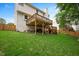 Backyard with a wood fence, mature trees, and multi-story wooden deck at 615 Southshore Pkwy, Durham, NC 27703