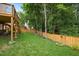 Large fenced backyard with mature trees and a multi-story deck at 615 Southshore Pkwy, Durham, NC 27703