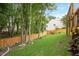 Lush backyard with mature trees and a wood fence at 615 Southshore Pkwy, Durham, NC 27703