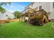 Backyard featuring a multi-story deck and a well-maintained lawn at 615 Southshore Pkwy, Durham, NC 27703