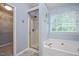 Bathroom features a large soaking tub and walk-in shower with neutral wall color at 615 Southshore Pkwy, Durham, NC 27703