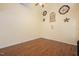 Bedroom with light, neutral walls, hardwood floors, and decorative wall art at 615 Southshore Pkwy, Durham, NC 27703
