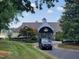 Beautiful lakeside community clubhouse with white trim and a circle driveway at 615 Southshore Pkwy, Durham, NC 27703