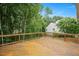 Wooden deck with railing and stairs leading to a scenic backyard at 615 Southshore Pkwy, Durham, NC 27703