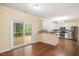 Dining area featuring an open layout, leading to the kitchen and outdoor deck at 615 Southshore Pkwy, Durham, NC 27703