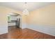 Formal dining room with hardwood floors, wainscoting, and elegant chandelier at 615 Southshore Pkwy, Durham, NC 27703