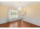 Formal dining room with hardwood floors, wainscoting, elegant chandelier and natural light at 615 Southshore Pkwy, Durham, NC 27703