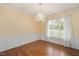 Formal dining room with hardwood floors, wainscoting, elegant chandelier and natural light at 615 Southshore Pkwy, Durham, NC 27703