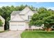 Charming two-story home boasts a manicured lawn, two-car garage, and lovely landscaping at 615 Southshore Pkwy, Durham, NC 27703