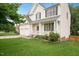 Charming two-story home boasts a manicured lawn, two-car garage, and lovely landscaping at 615 Southshore Pkwy, Durham, NC 27703