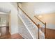 Bright foyer with hardwood floors, staircase, and chandelier leading to the upper level at 615 Southshore Pkwy, Durham, NC 27703