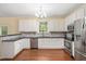 Beautiful kitchen features white cabinets, stainless steel appliances and black granite countertops at 615 Southshore Pkwy, Durham, NC 27703