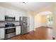Bright eat-in kitchen features stainless steel appliances and beautiful hardwood floors at 615 Southshore Pkwy, Durham, NC 27703