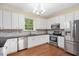 Updated kitchen with stainless steel appliances, light cabinets and hardwood flooring at 615 Southshore Pkwy, Durham, NC 27703