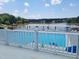Community pool with a view of the lake and plenty of seating at 615 Southshore Pkwy, Durham, NC 27703