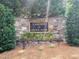 Stone entrance sign to Lakeside at Grove Park with lush greenery around the base at 615 Southshore Pkwy, Durham, NC 27703
