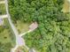 Aerial view of home surrounded by lush trees in a quiet neighborhood at 6717 Country Hollows Ln, Holly Springs, NC 27540