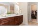 Bathroom featuring double sink vanity with granite countertops and large mirror at 6717 Country Hollows Ln, Holly Springs, NC 27540