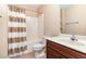 Neutral bathroom with tub/shower combo, tile flooring, and dark wood vanity at 6717 Country Hollows Ln, Holly Springs, NC 27540