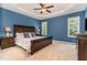 Primary bedroom with tray ceilings, ceiling fan, and plenty of natural light at 6717 Country Hollows Ln, Holly Springs, NC 27540