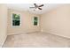 Bright bedroom with neutral walls and carpet and two large windows at 6717 Country Hollows Ln, Holly Springs, NC 27540