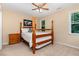 Comfortable bedroom features a ceiling fan and plenty of natural light at 6717 Country Hollows Ln, Holly Springs, NC 27540