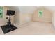 A carpeted bonus room with an exercise bike, great for a personal fitness area at 6717 Country Hollows Ln, Holly Springs, NC 27540