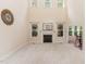 Spacious living room with a fireplace, carpeted flooring, and high ceilings with large windows at 6717 Country Hollows Ln, Holly Springs, NC 27540