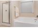 Bright bathroom showcasing a bathtub, shower, and window for natural light at 6717 Country Hollows Ln, Holly Springs, NC 27540