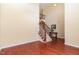 Elegant staircase with hardwood floors and decorative iron railing at 6717 Country Hollows Ln, Holly Springs, NC 27540