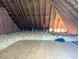 Exposed trusses in an attic or crawl space with insulation at 70 Dexterfield Dr, Fuquay Varina, NC 27526