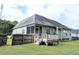 View of backyard with deck and screened-in porch, fenced perimeter, and gray vinyl siding at 70 Dexterfield Dr, Fuquay Varina, NC 27526