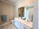 Bright bathroom with a double sink vanity, large mirror, and a view of the shower and bathtub at 70 Dexterfield Dr, Fuquay Varina, NC 27526
