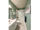 Bathroom featuring tiled shower with seating, modern vanity, and soothing green walls at 70 Dexterfield Dr, Fuquay Varina, NC 27526
