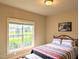 Inviting bedroom with a bright window view, comfortable bed, and side table at 70 Dexterfield Dr, Fuquay Varina, NC 27526