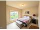 Comfortable bedroom featuring a window with a view of the front yard, a bed, and a side table at 70 Dexterfield Dr, Fuquay Varina, NC 27526