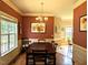 Traditional dining room with hardwood floors, chandelier, and large window at 70 Dexterfield Dr, Fuquay Varina, NC 27526