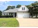 Charming single-story home featuring a two-car garage and well-maintained landscaping in a suburban setting at 70 Dexterfield Dr, Fuquay Varina, NC 27526