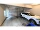A clean and organized garage with a modern car parked inside at 70 Dexterfield Dr, Fuquay Varina, NC 27526