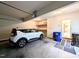 Bright garage features a white car, storage shelves, and easy access to interior at 70 Dexterfield Dr, Fuquay Varina, NC 27526
