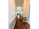 Hallway with hardwood floors, decorative trim, and leads to multiple rooms providing a spacious feel at 70 Dexterfield Dr, Fuquay Varina, NC 27526