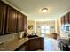 Spacious kitchen featuring dark wood cabinets, stone countertops, and stainless steel appliances at 70 Dexterfield Dr, Fuquay Varina, NC 27526