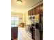 Bright kitchen with stainless steel appliances, tile floors, and wood cabinets at 70 Dexterfield Dr, Fuquay Varina, NC 27526