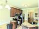 Well-lit kitchen equipped with stainless steel appliances and dark wood cabinetry at 70 Dexterfield Dr, Fuquay Varina, NC 27526