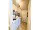 A compact laundry room featuring tile floors and a washer and dryer with shelving for storage at 70 Dexterfield Dr, Fuquay Varina, NC 27526
