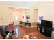 Spacious living room with hardwood floors, leading to the front door, and lots of natural light at 70 Dexterfield Dr, Fuquay Varina, NC 27526