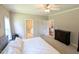 Bright main bedroom showcasing carpet floors, a large bed, and access to en-suite at 70 Dexterfield Dr, Fuquay Varina, NC 27526
