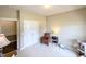 Cozy office space featuring a reading chair, pet supplies, and white double doors at 70 Dexterfield Dr, Fuquay Varina, NC 27526